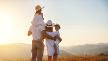 Happy family: mother, father, children son and  daughter on nature  on sunset