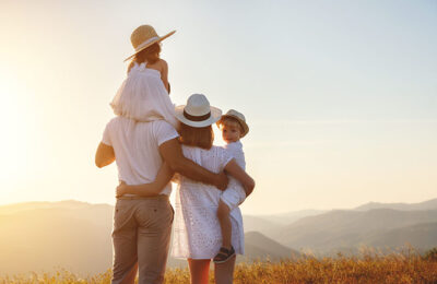 Happy family: mother, father, children son and  daughter on nature  on sunset