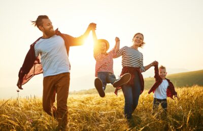 Happy family: mother, father, children son and  daughter on nature  on sunset